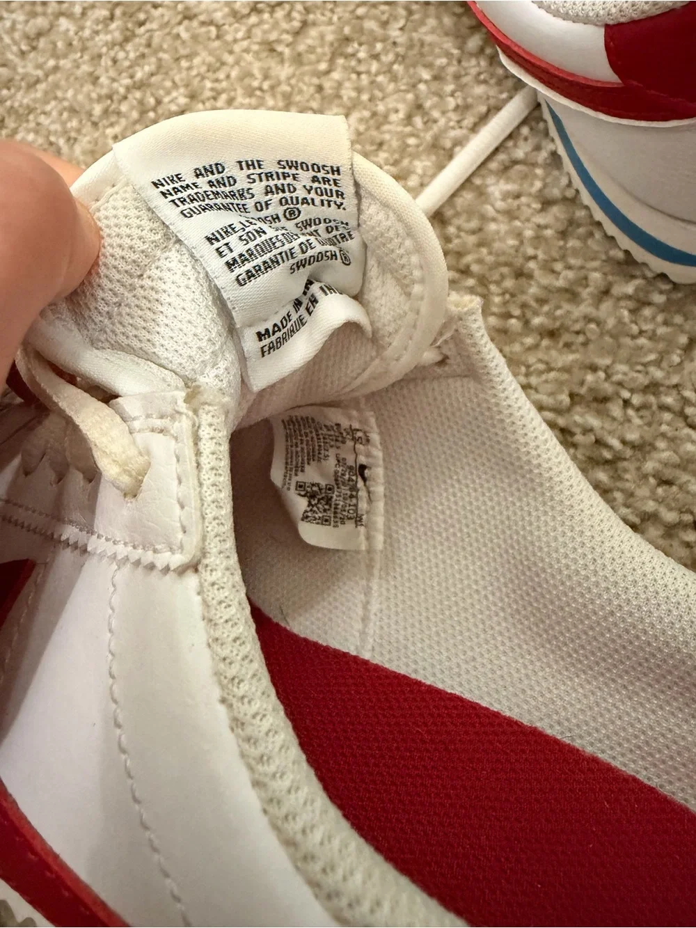 Nike White Sneakers with Red Swoosh and Blue Midsole Stripe